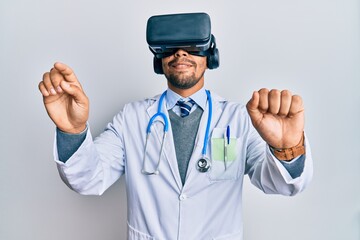 Wall Mural - Young arab doctor man smiling happy wearing uniform and using 3d glasses over isolated white background.