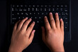© Yazmin DLC - Brown hands on small black keyboard