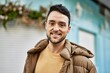 © Krakenimages.com - Young hispanic man smiling happy standing at the city.
