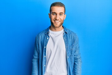 Sticker - Young caucasian man wearing casual clothes with a happy and cool smile on face. lucky person.