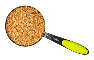 Wall Mural - view of golden flax seeds in measuring cup cutout