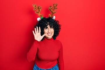 Poster - Young middle east woman wearing cute christmas reindeer horns showing and pointing up with fingers number five while smiling confident and happy.