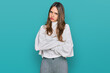 © Krakenimages.com - Young brunette woman wearing casual turtleneck sweater skeptic and nervous, disapproving expression on face with crossed arms. negative person.