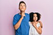 © Krakenimages.com - Young hispanic family of brother and sister wearing casual clothes together thinking concentrated about doubt with finger on chin and looking up wondering