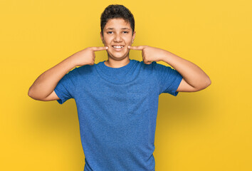 Sticker - Teenager hispanic boy wearing casual clothes smiling cheerful showing and pointing with fingers teeth and mouth. dental health concept.