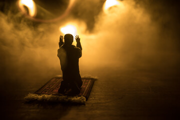 Silhouette of mosque building on toned foggy background. Ramadan Kareem background. Mosque at sunset. Praying people