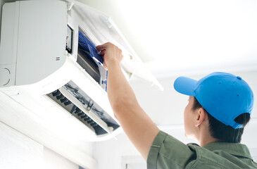 Male repair and wash air conditioner at room, He is air technician , mechanic , engineer. Maintenance air conditioner myself.