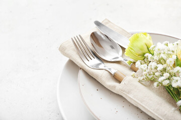 Beautiful table setting with floral decor on light background, closeup