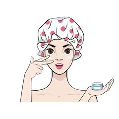 Beautiful girl in a shower cap applies a moisturizing anti-aging cream to her face. Skin care