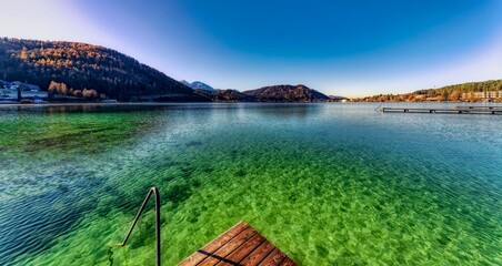 landscape with lake and mountains and green water