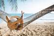 canvas print picture - Traveler asian woman relax in hammock on summer beach Thailand