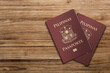 A Philippine passport is both a travel document and a primary national identity document issued to citizens of the Philippines ,Two passports on a wooden floor
