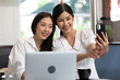 © offsuperphoto - young couple woman taking photo or selfie together from smartphone in free time