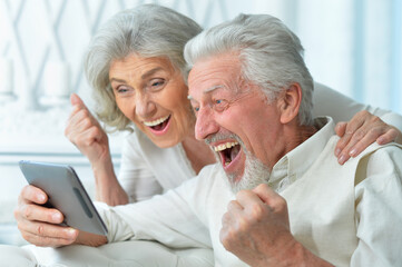 Sticker - portrait of a happy senior couple using tablet