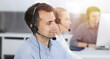 © Iryna - Call center. Group of casual dressed operators at work. Adult businessman in headset at customer service office. Telesales in business