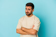 © Asier - Young caucasian man isolated on blue background unhappy looking in camera with sarcastic expression.