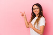 © Asier - Young mexican woman isolated on pink background excited pointing with forefingers away.