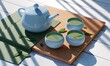 Teapot and teacup in a sky blue cup with green leaf, Teatime concept, 3d rendering