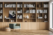 © ImageFlow - Stylish modern interior of contemporary library with comfortable armchair. Book with bookshelf. Wooden parquet floor.