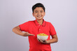 Indian kid or boy eating noodles.