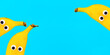 Banner with banana fruits with funny googly eyes on bright blue background with copy space