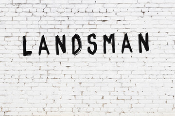 Inscription landsman painted on white brick wall