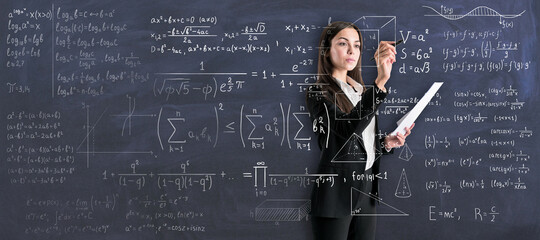 Wall Mural - Studying process with young woman in black suit writing on transparent wall math calculations.