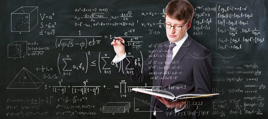 Wall Mural - Higher education concept with student carrying textbook and writing on glass board math calculations.