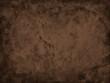 © Arlenta Apostrophe - Brown background with old vintage texture. Elegant antique black grunge on dark brown background in vintage metal design. Brown painted wall.