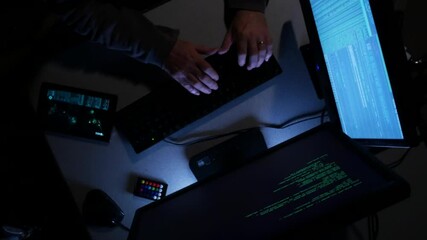 Overhead shot of computer hacker typing code