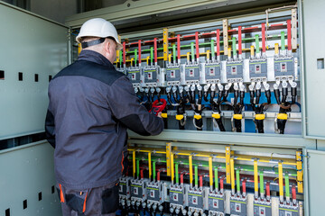 Wall Mural - checking the operating voltage levels of the solar panel switchgear compartment