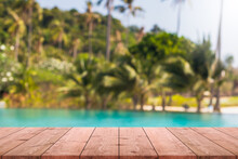 Empty Wood Table Top And Blurred Swimming Pool In Tropical Resort In Summer Banner Background - Can Used For Display Or Montage Your Products.