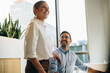 © Jacob Lund - Colleagues smiling while working together
