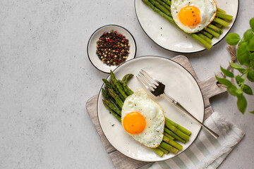 Poster - Homemade asparagus with stir-fried eggs, top view, light grey background. Copy space.