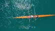 Aerial drone  video of sport canoe operated by team of young men in emerald clear sea