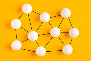 balls connected to each other representing a network structure. communication, connection or network