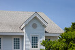 © Rattanachat - Roof shingles with garret house on top of the house among a lot of trees. dark asphalt tiles on the roof background