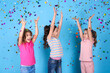 © New Africa - Adorable little children and falling confetti on light blue background