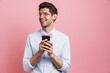 © Drobot Dean - Young white man wearing bow tie smiling and using cellphone