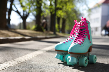 Wall Mural - stylish pink roller skates outdoors on sunny day. space for text
