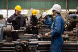 Fototapeta  - Group of male engineer worker maintenance machine in industry factory. Male technician worker working, repair machine lathe metal in the industry factory