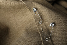 Metal Safety Pins On Fabric, Closeup View