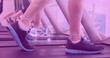 Composition of digital interface over woman's legs exercising on treadmill with pink tint