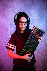 Gamer girl playing with computer at home. Young female posing with computer keyboard.