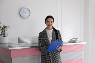 Poster - Receptionist with clipboard near countertop in office