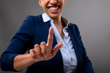 Mid Section Of African American Businesswoman Touching Invisible Screen Against Grey Background