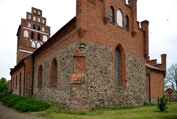 General view and architectural details in close. Catholic church dedicated to the Assumption of the Blessed Virgin Mary. Built in the second half of the 14th century in the town of Galiny, warmi in Po