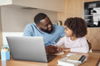© Stock 4 You - Happy young parent father help child daughter with distance learning from home