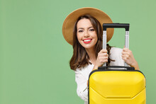 Close Up Cheerful Fun Traveler Tourist Woman In Casual Clothes Hat Hiding With Yellow Suitcase Valise Isolated On Green Background Passenger Travel Abroad Weekend Getaway Air Flight Journey Concept