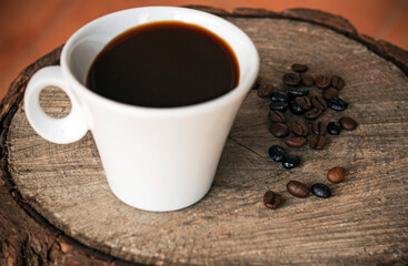 Cup of coffee and beanscoffee on a wood